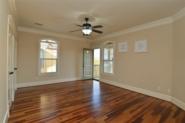 unfurnished room featuring ceiling fan, wood finished floors, baseboards, and ornamental molding
