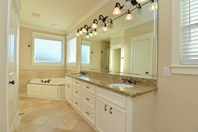 bathroom with a bath, a sink, tile patterned floors, crown molding, and double vanity