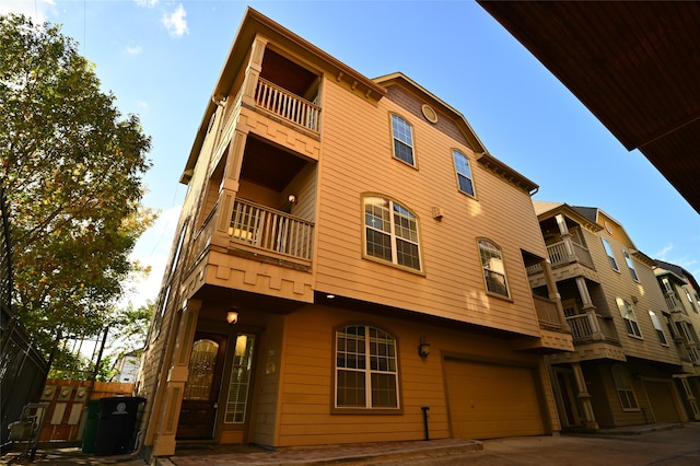 view of building exterior with concrete driveway and a garage