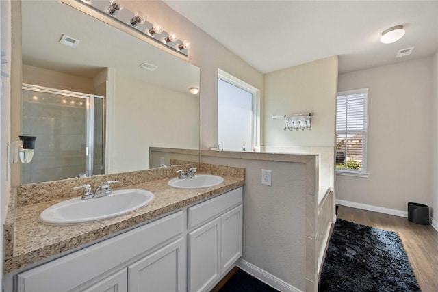 3730 Giorgio Pastel Pl, Katy, TX 77493 - full bath featuring a stall shower, visible vents, a sink, and wood finished floors