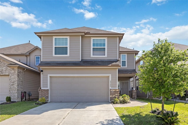 3730 Giorgio Pastel Pl, Katy, TX 77493 - view of front facade with roof with shingles, an attached garage, brick siding, driveway, and a front yard
