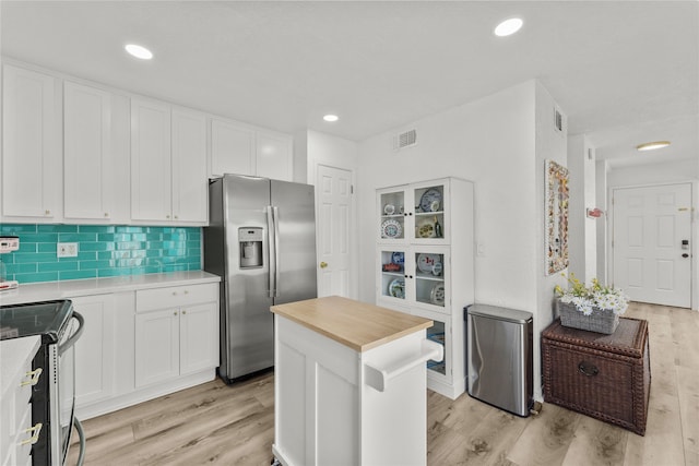 501 Jean Lafitte Cv, Galveston, TX 77554 - kitchen featuring white cabinetry, wooden counters, light wood-style floors, and stainless steel appliances