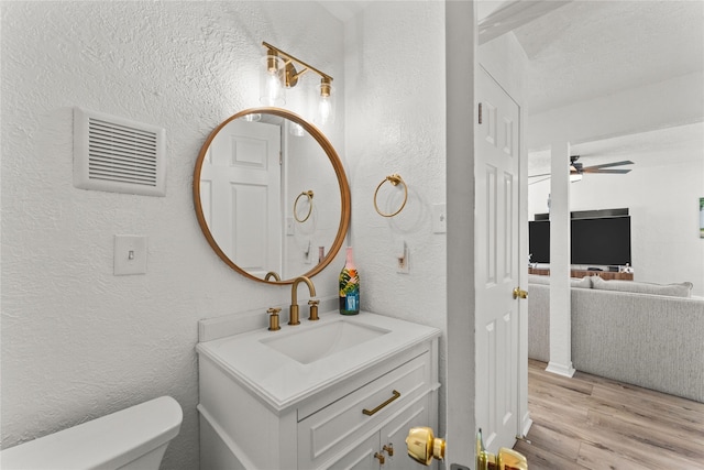 501 Jean Lafitte Cv, Galveston, TX 77554 - bathroom with toilet, ceiling fan, visible vents, wood finished floors, and a textured wall