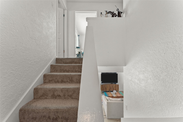 501 Jean Lafitte Cv, Galveston, TX 77554 - staircase with a textured wall