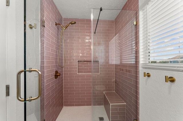 501 Jean Lafitte Cv, Galveston, TX 77554 - bathroom featuring a textured ceiling and a stall shower