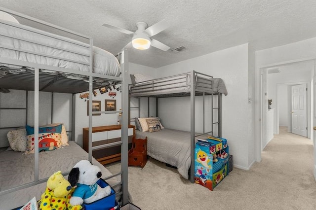 501 Jean Lafitte Cv, Galveston, TX 77554 - carpeted bedroom featuring a ceiling fan, baseboards, visible vents, and a textured ceiling