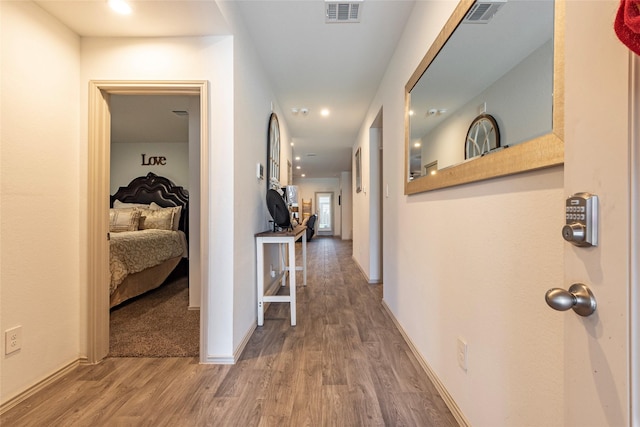 9705 Wall St, Texas City, TX 77591 - corridor featuring baseboards, visible vents, and wood finished floors