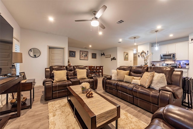 9705 Wall St, Texas City, TX 77591 - living room with ceiling fan, light wood-type flooring, visible vents, and recessed lighting