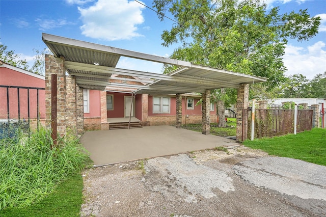 rear view of house with brick siding and fence
