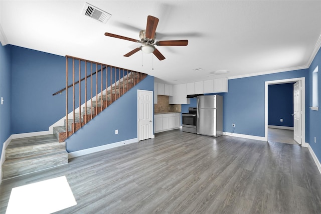 unfurnished living room with ceiling fan, baseboards, visible vents, and wood finished floors