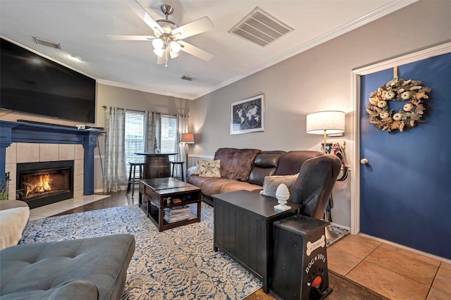 9203 Baber Run Cir, Houston, TX 77095 - living room with crown molding, a ceiling fan, light tile patterned floors, a fireplace, and baseboards