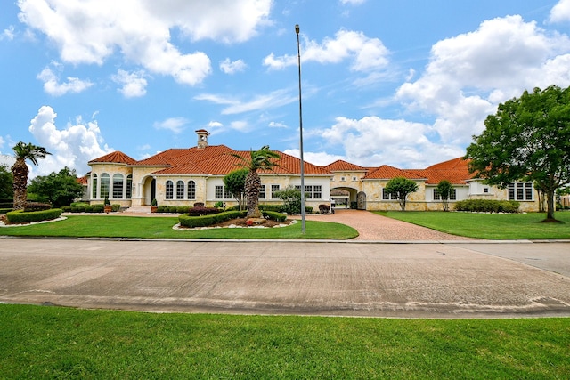 2718 Silverhorn Dr, Katy, TX 77450 - mediterranean / spanish-style home featuring a tiled roof, decorative driveway, a front yard, and stucco siding