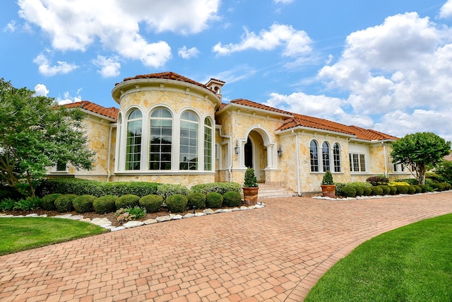 2718 Silverhorn Dr, Katy, TX 77450 - mediterranean / spanish home with stone siding, a tile roof, and stucco siding