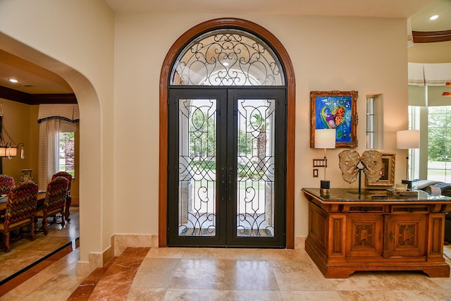 2718 Silverhorn Dr, Katy, TX 77450 - entrance foyer with french doors and arched walkways