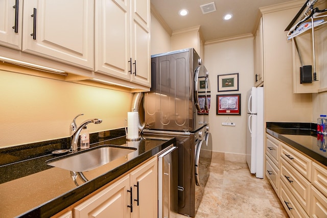 2718 Silverhorn Dr, Katy, TX 77450 - washroom with estacked washer and dryer, ornamental molding, and recessed lighting