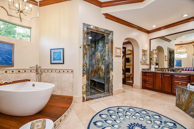 2718 Silverhorn Dr, Katy, TX 77450 - full bath with a chandelier, a stall shower, ornamental molding, a soaking tub, and vanity