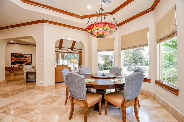 2718 Silverhorn Dr, Katy, TX 77450 - dining room featuring arched walkways, ornamental molding, a tray ceiling, and recessed lighting