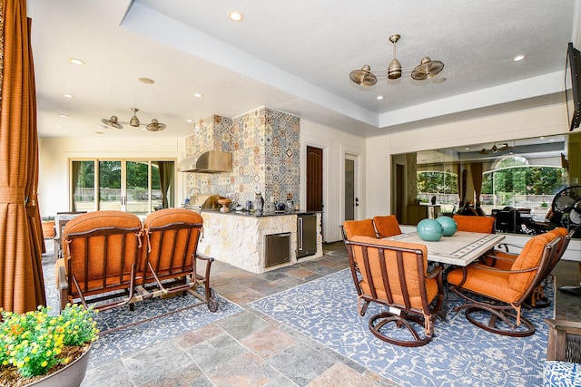 2718 Silverhorn Dr, Katy, TX 77450 - dining room featuring stone tile floors, a chandelier, a raised ceiling, and recessed lighting