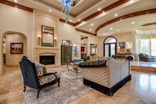 2718 Silverhorn Dr, Katy, TX 77450 - living room with recessed lighting, crown molding, arched walkways, a large fireplace, and a towering ceiling
