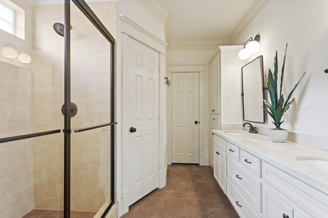 full bathroom with a shower stall, double vanity, crown molding, and tile patterned floors