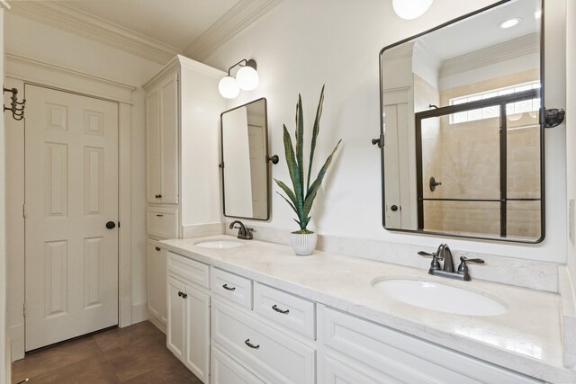 bathroom featuring crown molding, double vanity, and a tile shower