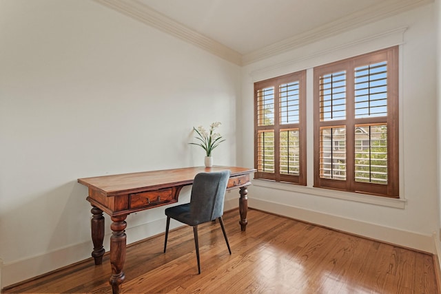 home office featuring crown molding, wood finished floors, and baseboards