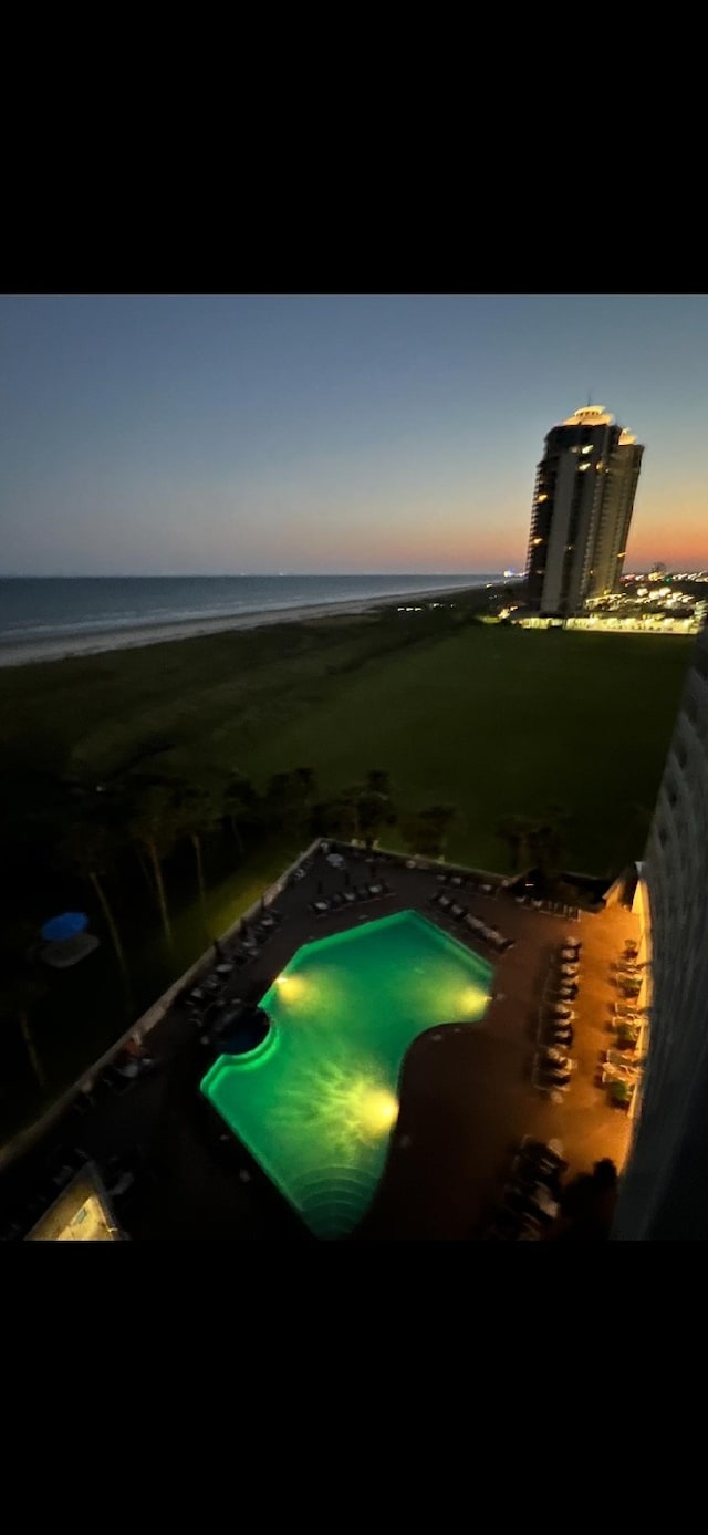 1401 E Beach Dr Unit 809, Galveston, TX 77550 - aerial view at dusk of view of pool and a water view