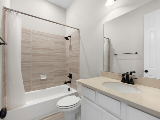 bathroom with shower / bath combination with curtain, toilet, and vanity