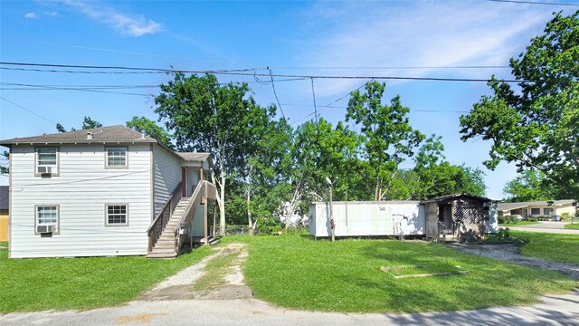 1314 Burbank St, Baytown, TX 77520 - view of front of property with stairway, a front lawn, and driveway
