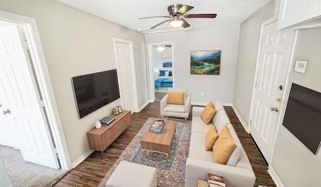 1314 Burbank St, Baytown, TX 77520 - living area featuring baseboards, a ceiling fan, and dark wood-type flooring