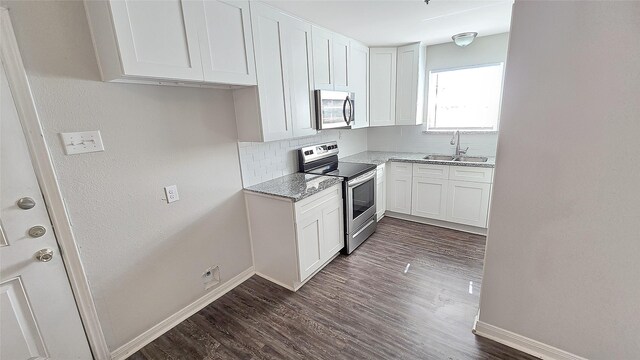 1314 Burbank St, Baytown, TX 77520 - kitchen featuring baseboards, stainless steel appliances, tasteful backsplash, and a sink