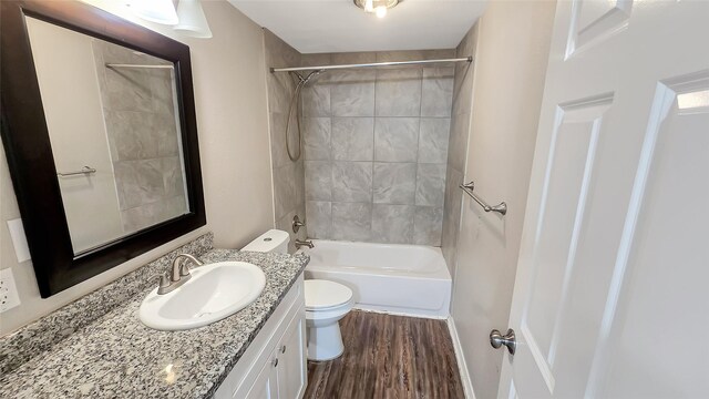 1314 Burbank St, Baytown, TX 77520 - bathroom with vanity, toilet, wood finished floors, and shower / tub combination