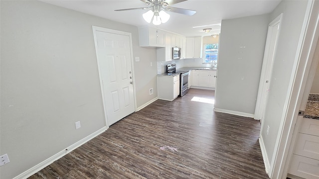 1314 Burbank St, Baytown, TX 77520 - kitchen featuring ceiling fan, dark wood finished floors, white cabinets, and appliances with stainless steel finishes