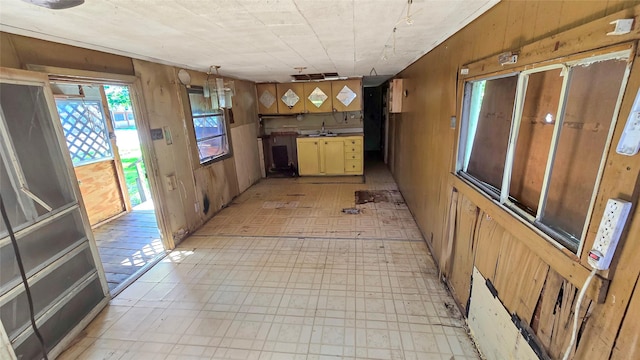 1314 Burbank St, Baytown, TX 77520 - kitchen featuring a sink, light floors, and wood walls