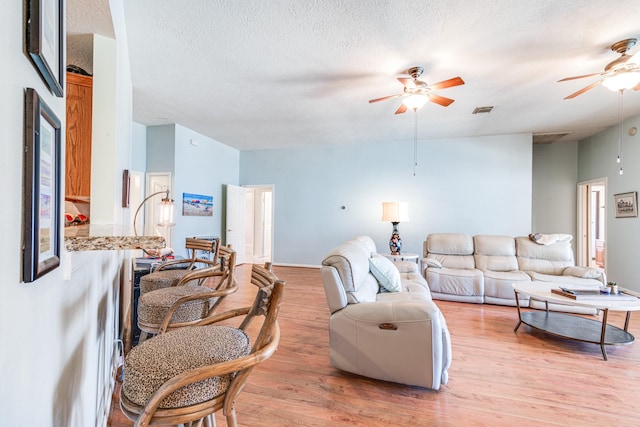 410 Scarlet Sage Dr, League City, TX 77573 - living area with a ceiling fan, light wood-style flooring, and a textured ceiling