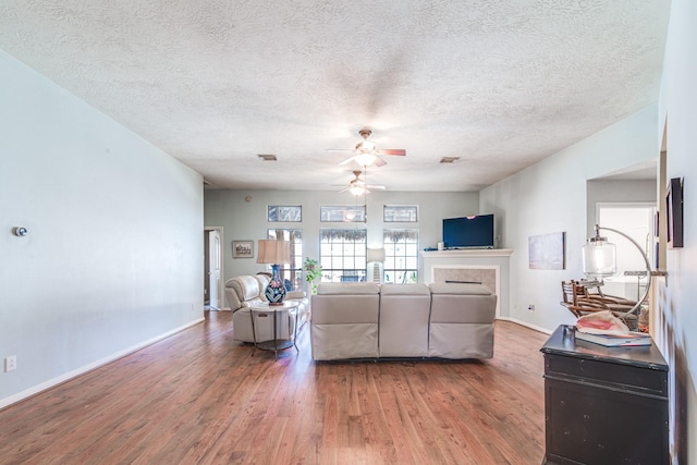 410 Scarlet Sage Dr, League City, TX 77573 - living room featuring wood finished floors, a ceiling fan, and a textured ceiling