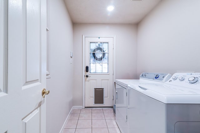 410 Scarlet Sage Dr, League City, TX 77573 - laundry area featuring washing machine and clothes dryer and light tile patterned floors