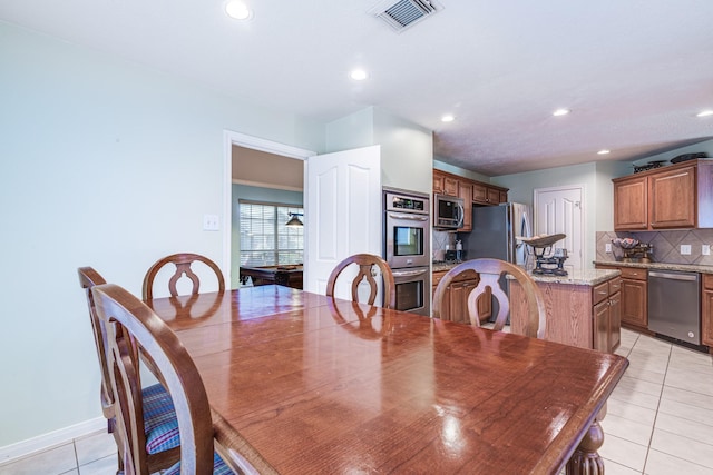 410 Scarlet Sage Dr, League City, TX 77573 - dining space with light tile patterned floors and recessed lighting