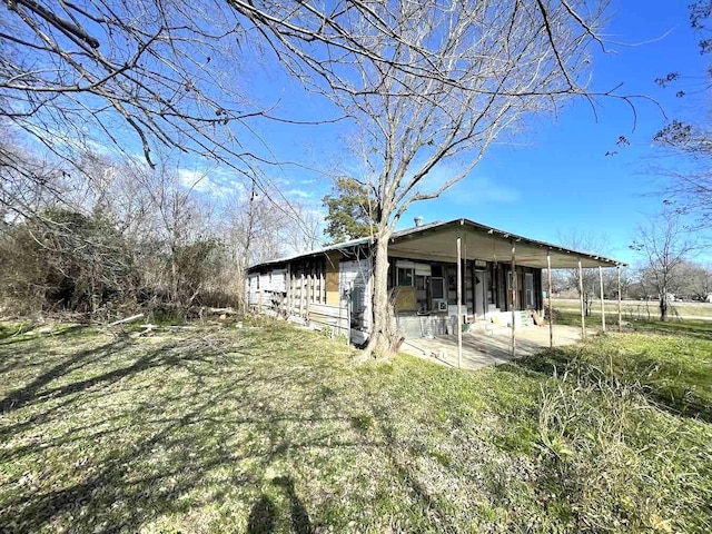 view of side of home featuring a sunroom and a patio area