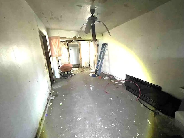 unfurnished living room with concrete floors and a ceiling fan
