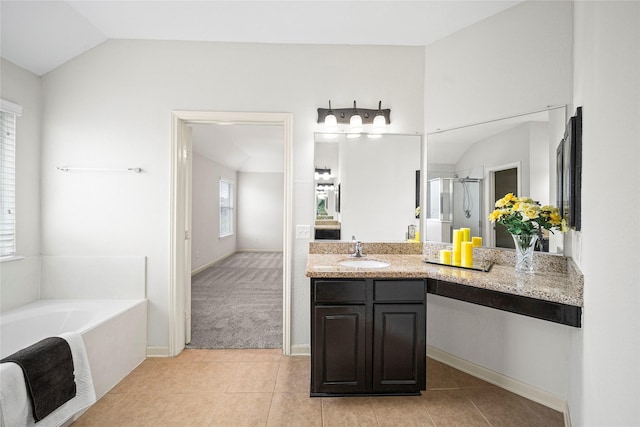 full bath with tile patterned flooring, a bath, a stall shower, vanity, and lofted ceiling