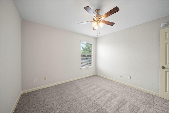 unfurnished room featuring ceiling fan, carpet floors, and baseboards