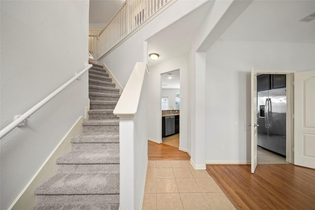 stairs featuring tile patterned flooring