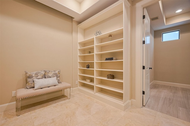 interior space with visible vents, baseboards, and built in features