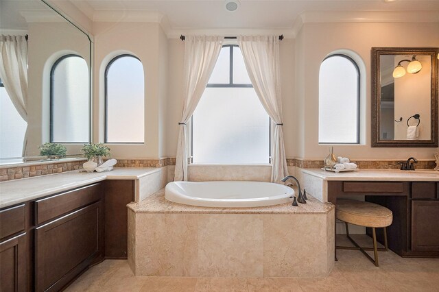 bathroom with a garden tub, vanity, and crown molding