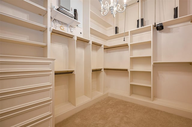 spacious closet featuring carpet flooring and a chandelier