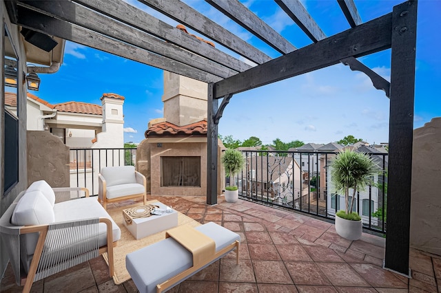 view of patio with a balcony, a pergola, and an outdoor living space with a fireplace
