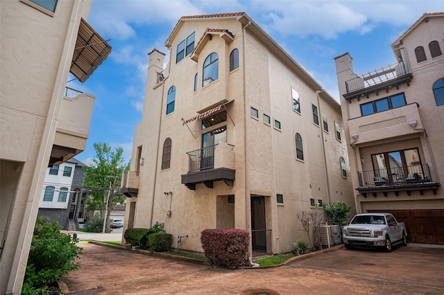 view of building exterior with concrete driveway and an attached garage