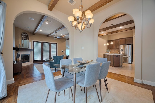 dining space featuring visible vents, recessed lighting, an inviting chandelier, beamed ceiling, and arched walkways
