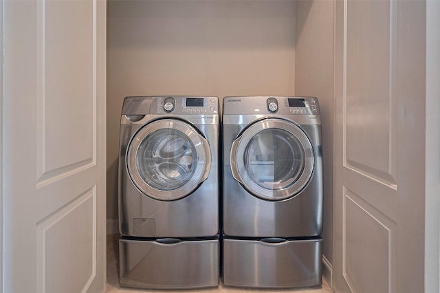 clothes washing area featuring washing machine and dryer and laundry area